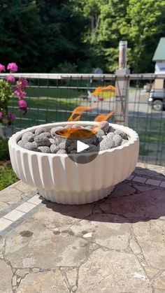 a fire pit sitting on top of a stone patio