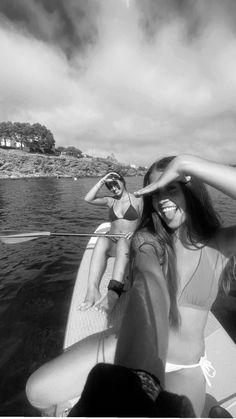 two women riding on the back of a boat