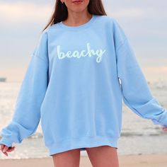 Beachy Coverup Sweatshirt A unisex heavy blend crewneck sweatshirt is pure comfort. These garments are made from polyester and cotton. This combination helps designs come out looking fresh and beautiful. The collar is ribbed knit, so it retains its shape even after washing. There are no itchy side seams on these sweaters. * 50% cotton, 50% polyester * Pre-shrunk * Classic fit with no center crease * 1x1 athletic rib knit collar with spandex * Air-jet spun yarn with a soft feel and reduced pillin Minimalist Sweater, Aesthetic College, College Crewneck, Florida Shirt, Jones Beach, Varsity Sweatshirt, Beach Sweatshirt, California Shirt, Sweatshirt Aesthetic