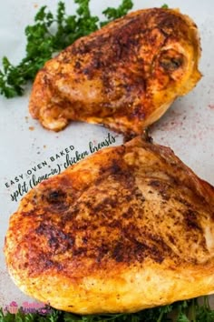 two pieces of chicken sitting on top of a piece of paper next to parsley