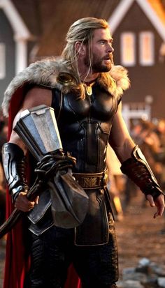 thor is standing in the middle of a street with his hands on his hips and wearing armor