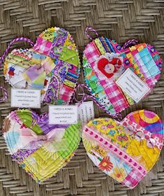 four heart shaped tags are sitting on a wicker table cloth covered basket with labels