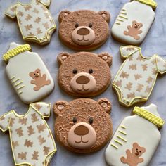 baby shower cookies with teddy bears and onesuits on them are ready to be eaten