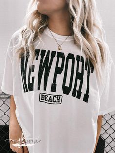 Newport Beach Comfort Colors Shirt - Jewels Kennedy Designs Casual Beach Season Tops, Casual Beach Season Tops For Leisure, Casual Tops For Beach Season Leisure, Casual Beach Tops For Leisure, Vacation Graphic Tee Shirt With Letter Print, White Text Print Top For Vacation, Graphic Tee With Letter Print For Leisure, Sporty Short Sleeve Tops For Beach Season, Sporty Tops For Beach Season Vacation