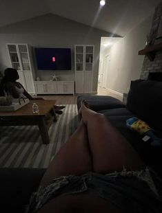 the person is watching tv in the living room