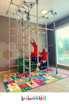 two children are playing in a play area with ladders and balls on the floor