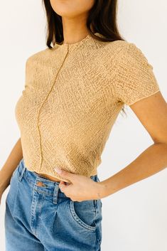 this not-so-basic cropped top will take you from day to night, season after season. made in the perfect neutral tan color, it’s slightly sheer + has a chic high neckline. a must-have ‘going out’ top or elevated basic top to add to your spring // summer wardrobe. tan // high neckline, mesh overlay, attached tank lining, adjustable lining straps, seam detailing, cropped paired with our corbin pleated denim model is 5'8" + wearing a small measurements are approximate + taken while laying flat small : bust 32” length 19” medium : bust 34” length 19” large : bust 36" length 19" more fit + fabric info : polyester // fabric has little stretch // fits true to size Spring Sheer Cropped Crop Top, Trendy Mock Neck Top For Night Out In Spring, Trendy Fitted Mock Neck Top For Summer, Spring Cropped Crop Top For Layering, Chic High Neck Crop Top For Summer, Sheer Beige Stretch Top, Beige Sheer Stretch Top, Stretch Beige Sheer Top, Stretch Sheer Beige Tops