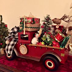 a red truck filled with christmas presents on top of a table