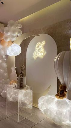 the interior of a store with balloons and lights on display in front of an arch