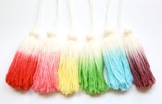 four different colors of tassels on a white background