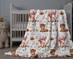 a baby crib with a teddy bear blanket on it