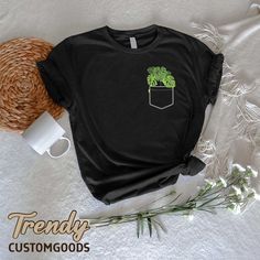 "Monstera Pocket Shirt,Plant Lady TShirt,Plant Lover Gift,Plant Mom Tee,Nature Lover Shirt,Botanical Shirt,Gardening Shirt,Monstera Leaves ----- How To Order ----- 1-) Please, check and review all the photos. 2-) Choose your t-shirt size and color. *Different styles of shirts may have different shades of same color choice due to different manufacturer brands. *For this reason, we recommend you to match shirts from the same styles if you want precisely matching colors (ex. Unisex, V-necks, Toddle Green Pocket T-shirt For Spring, Green Spring T-shirt With Pockets, Green T-shirt With Pockets For Spring, Eco-friendly Ink Tops With Relaxed Fit And Short Sleeves, Casual Crew Neck T-shirt With Eco-friendly Ink, Casual Black T-shirt With Plant Print, Casual Summer Tops With Plant Details, Nature-inspired Cotton Top With Plant Print, Green Relaxed Fit Shirt With Plant Print