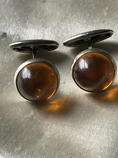 Circa 1930's cufflinks. Gold Glass stone set in a white metal alloy. Feel free to convo me with any further questions. Thank you for your interest. French Cuff, French Cuff Shirts, Unisex Accessories, Vintage Cufflinks, Gold Glass, White Metal, Tie Accessories, Suit And Tie, Vintage Accessories