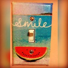 a watermelon light switch plate with the word smile painted on it's side