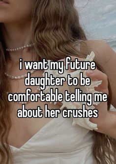 a woman with long hair holding a seashell in her hand and the words i want my future daughter to be comfortable telling me about her crushes