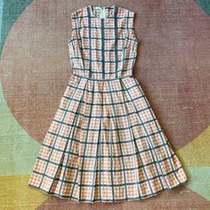 "50s Pink Plaid Day Dress🌸 This adorable dress is from the 1950s! It was designed by Helen Whiting who started making sportswear and day dresses in 1949! It has a cute pink and grey plaid print. It has two metal zippers one at the back of the neck and one at the side. In good vintage condition with no noticeable flaws! Fits like a XS! Please see measurements below to ensure proper fit! Bust: 16\" Shoulder to shoulder: 13.5\" Waist: 12\" Sweep: 34\" Length: 38\"" Vintage Sleeveless Plaid Cotton Dress, Vintage Knee-length Plaid Dress For Spring, Vintage A-line Plaid Dress, Vintage Sleeveless Spring Plaid Dress, 1950s Plaid Spring Dresses, White Swimsuit, Grey Plaid, Vestidos Vintage, Pink Plaid