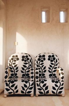 two black and white chairs sitting next to each other