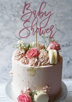 a baby shower cake decorated with pink flowers