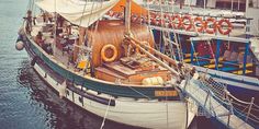 an old sailboat is docked in the water