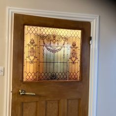 a wooden door with a stained glass window