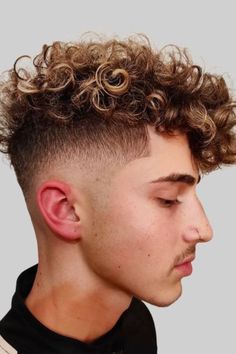 Discover the sleek and modern Curly High Fade, a top choice for men with curly hair! This stylish haircut combines the clean lines of a high fade with the natural texture of curls, creating a dynamic and eye-catching look. Perfect for those who want to showcase their curls while maintaining a polished appearance. Explore more haircuts for curly hair men to find the perfect style that suits your personality and enhances your confidence! Mohawk Hairstyles For Men, Curly Mohawk Hairstyles, High Fade Haircut, Mohawk Hairstyles Men, Curly Hair Fade