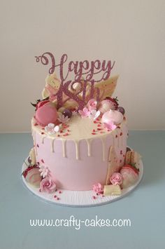 a birthday cake with pink frosting and decorations