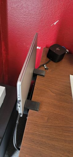 a computer monitor sitting on top of a wooden desk