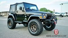 a black jeep parked in a parking lot