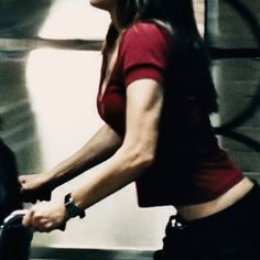 a woman riding a stationary bike in a gym