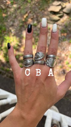 a woman's hand with four rings on it and the word cuba written in white