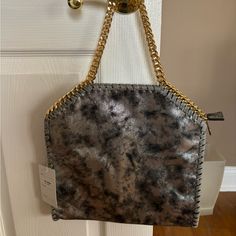 Never Used! Stormy Grey Bag With Gold Accents. Zipper On The Back And The Inside Of Bag Gray Rectangular Shoulder Bag With Gold-tone Hardware, Gray Leather Bag With Gold-tone Hardware, Silver Tote Shoulder Bag With Gold-tone Hardware, Leopard Print Bags With Gold-tone Hardware For Shopping, Grey Bag, Luxury Leopard Print Shoulder Bag With Gold-tone Hardware, Gold Accents, Accent Colors, The Back