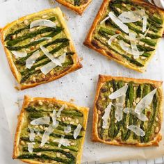 four pieces of bread with asparagus and parmesan cheese