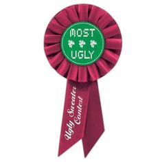 a red rosette with the words most ugly written in green and white on it