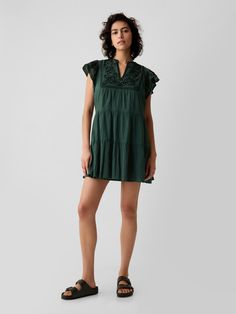 Soft crinkle gauze cotton mini dress.  V-neck.  Short flutter sleeves.  Tiered skirt.  Embroidery at top.  *Fit: Slim.  An A-line silhouette that sits close to the body with a flared opening.  Hits above the knee.  Model is approx.  5’10” wearing Skirt Embroidery, Embroidered Mini Dress, Cotton Mini Dress, Toddler Christmas, Tier Skirt, Tiered Skirt, Flutter Sleeves, The Gap, Men Boys