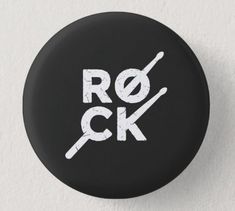 a black button with the word rock printed in white on it's front side