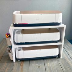 a printer sitting on top of a white shelf