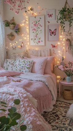 a bedroom decorated in pink and white with fairy lights