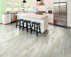 a kitchen with an island and three stools