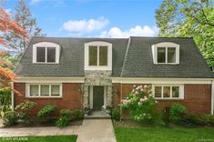 a brick house with white trim and windows