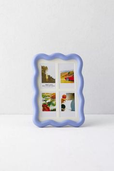 a blue and white photo frame sitting on top of a table