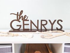 a wooden sign that says the genry's on top of a white table