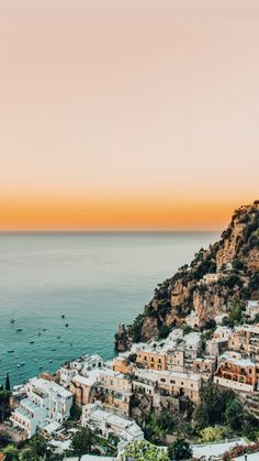 an aerial view of the town of positi at sunset