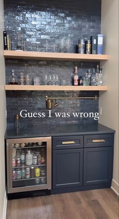 a kitchen with shelves filled with bottles and glasses on top of the counter, next to an open refrigerator freezer that says guess i was wrong