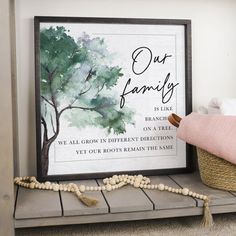 a sign that reads out family is placed on a shelf next to a basket and blanket