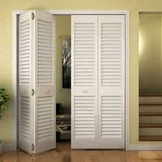 two white doors are open in a room