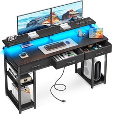 two computer monitors sitting on top of a desk