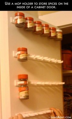 an image of spice rack with jars on the top and bottom shelves above it that are labeled use mop holes to store spices on the inside of a cabinet door