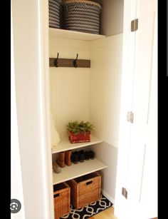 an open closet with baskets and shoes on the shelves