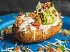 a loaded baked potato on a blue plate