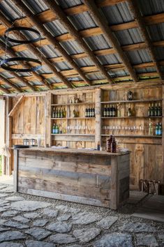 a wooden bar with lots of bottles on it